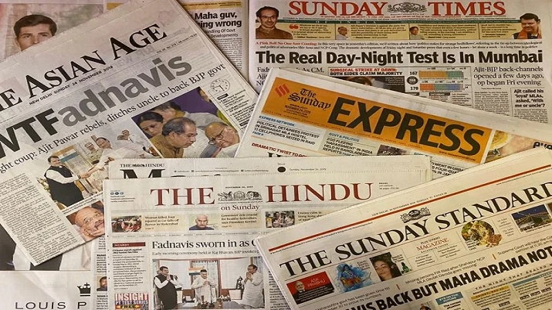 Students Preparing For Exam While Reading Newspaper